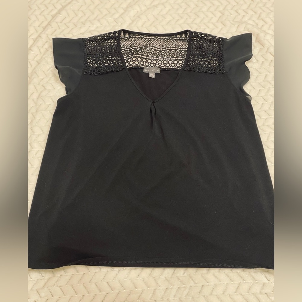 Women’s Black flowy blouse with lace on upper back.